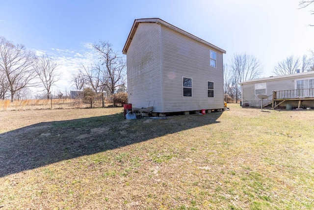 rear view of house featuring a yard