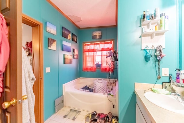 bathroom featuring a garden tub, ornamental molding, a textured ceiling, tile patterned flooring, and vanity