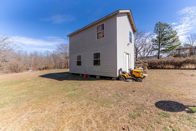 view of side of property featuring a yard