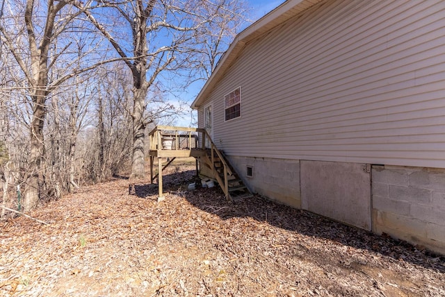 view of home's exterior featuring stairs, a wooden deck, and crawl space