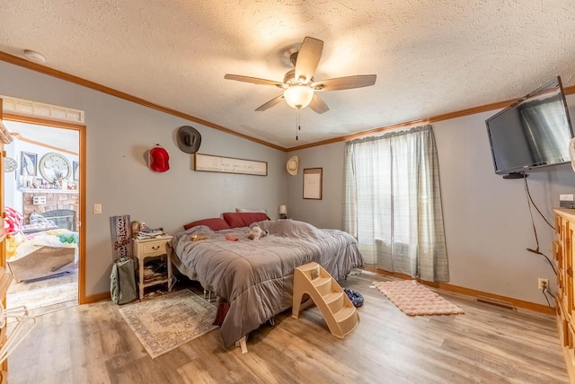 bedroom with light wood finished floors, a textured ceiling, and crown molding