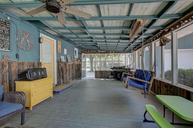 sunroom / solarium featuring a healthy amount of sunlight and ceiling fan