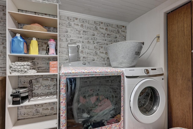 washroom featuring laundry area, ornamental molding, and separate washer and dryer