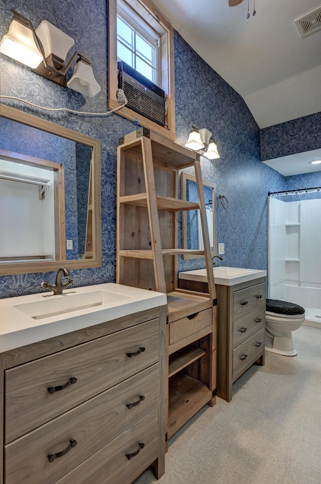 bathroom with vanity, visible vents, wallpapered walls, lofted ceiling, and a shower