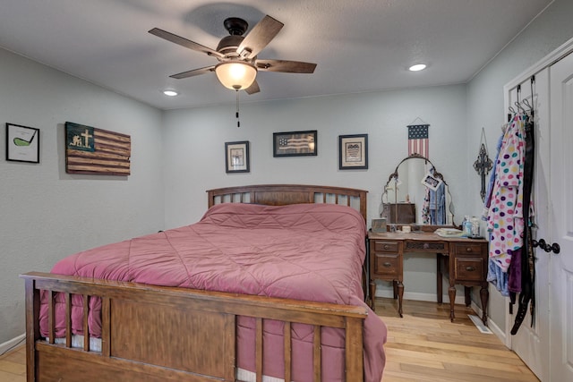 bedroom with light wood finished floors, recessed lighting, a ceiling fan, and baseboards