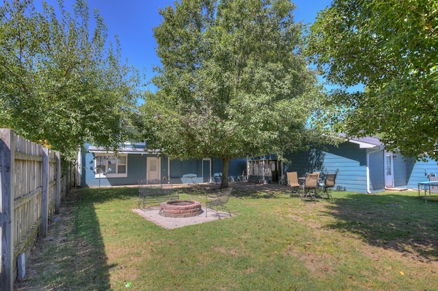 view of yard with a fire pit and a fenced backyard