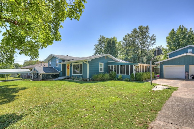 view of front of property featuring an outdoor structure, concrete driveway, a front yard, and a sunroom