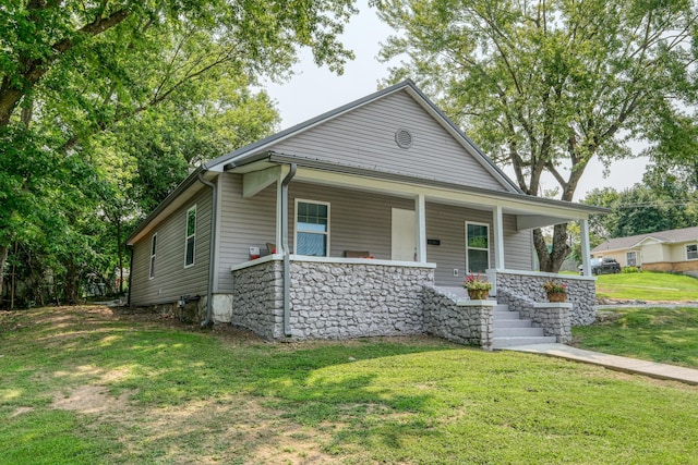 view of front of house with covered porch and a front lawn