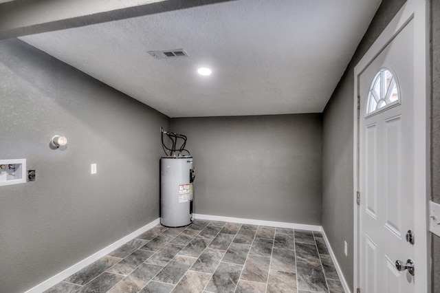 laundry area featuring visible vents, electric water heater, baseboards, washer hookup, and hookup for an electric dryer