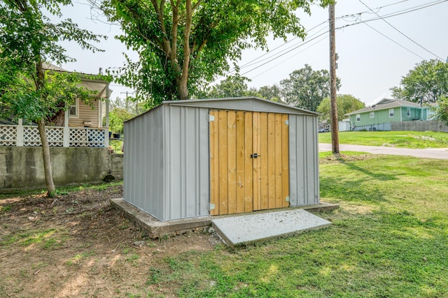 view of shed featuring fence