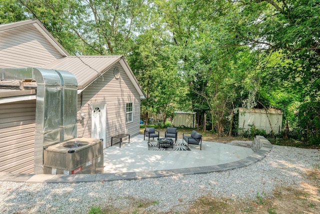 view of patio / terrace featuring a fire pit and central AC