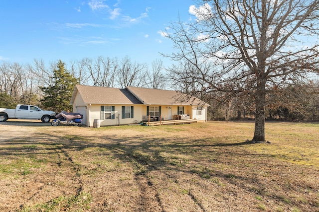 ranch-style home featuring a front lawn and an attached garage