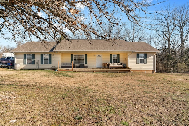 back of property featuring a wooden deck, a yard, and roof with shingles