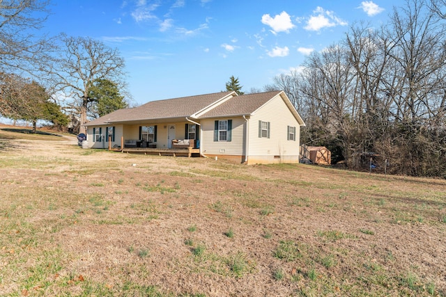 rear view of property featuring a deck and a yard