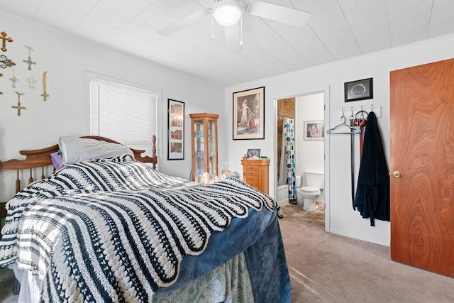 carpeted bedroom featuring connected bathroom, baseboards, and a ceiling fan