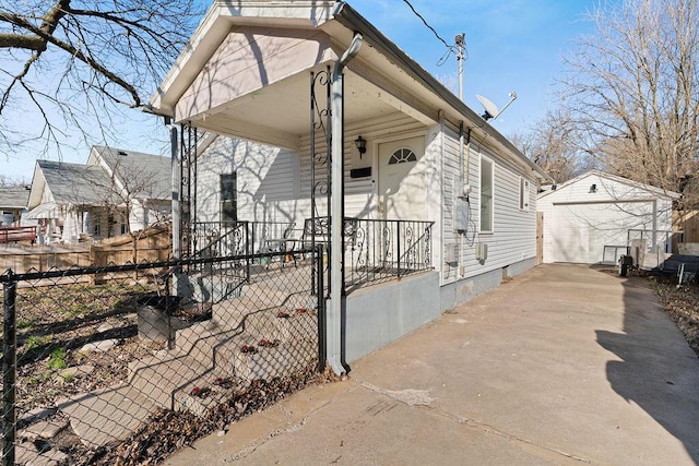 view of front of property with a garage, covered porch, an outdoor structure, and fence