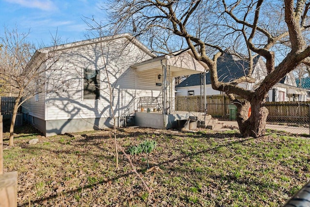 back of property featuring fence