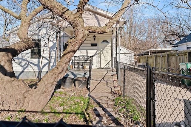 view of side of property featuring a gate and fence