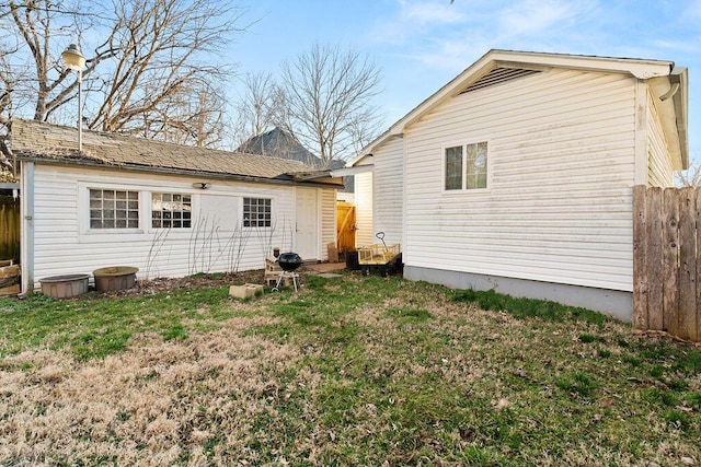 exterior space with a lawn and fence