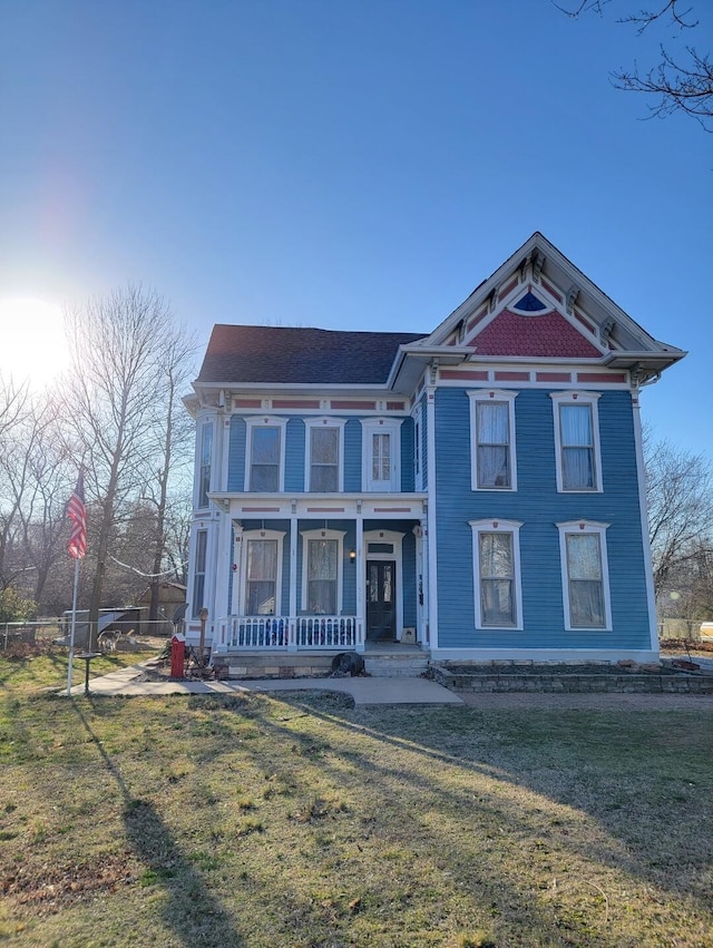 victorian house with covered porch and a front lawn