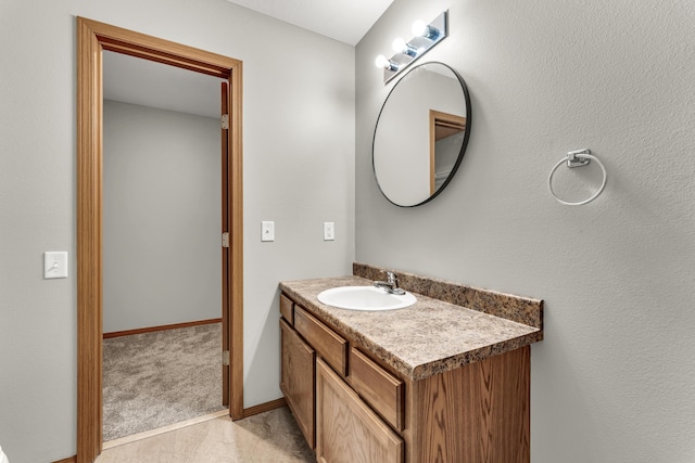 bathroom featuring baseboards and vanity