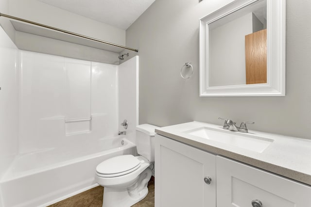 bathroom featuring toilet, vanity, and  shower combination