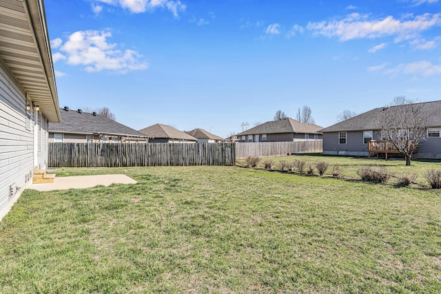 view of yard with a residential view and a fenced backyard