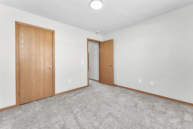 unfurnished bedroom with carpet and baseboards