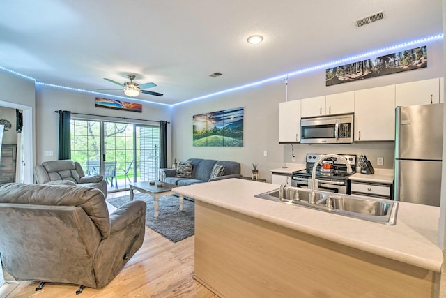 living room featuring visible vents, ceiling fan, and light wood-style floors