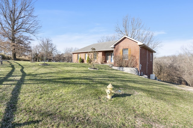 view of front of property featuring a front lawn and brick siding