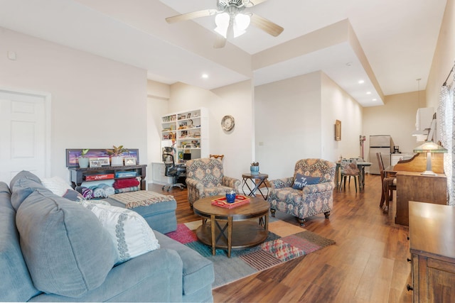 living room featuring recessed lighting, a ceiling fan, and wood finished floors