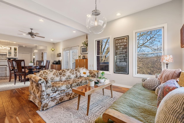 living room featuring recessed lighting, baseboards, wood finished floors, and a ceiling fan