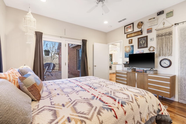 bedroom with recessed lighting, visible vents, wood finished floors, and access to outside