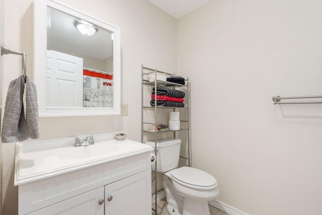 full bath featuring baseboards, toilet, and vanity