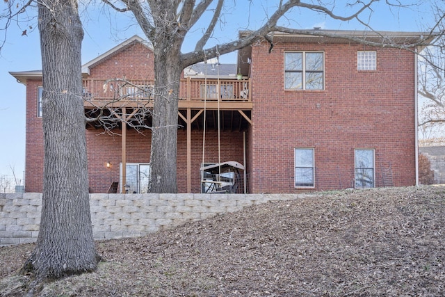 back of house featuring brick siding