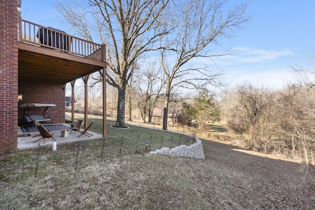 view of yard with a wooden deck and a patio