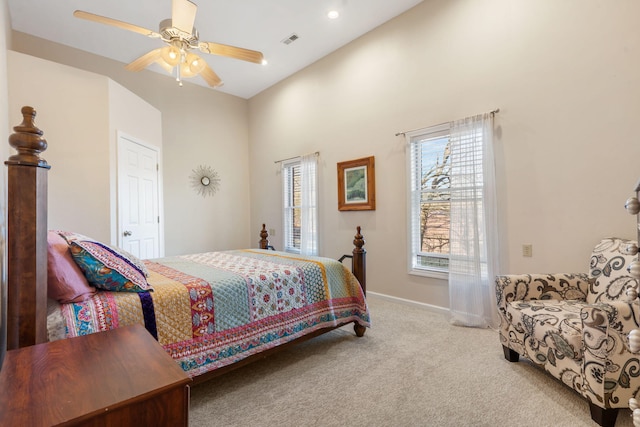 carpeted bedroom with visible vents, a ceiling fan, and baseboards