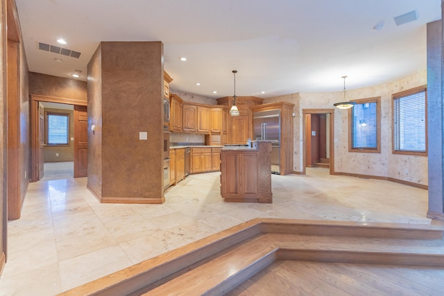 kitchen featuring visible vents, a center island, baseboards, recessed lighting, and hanging light fixtures