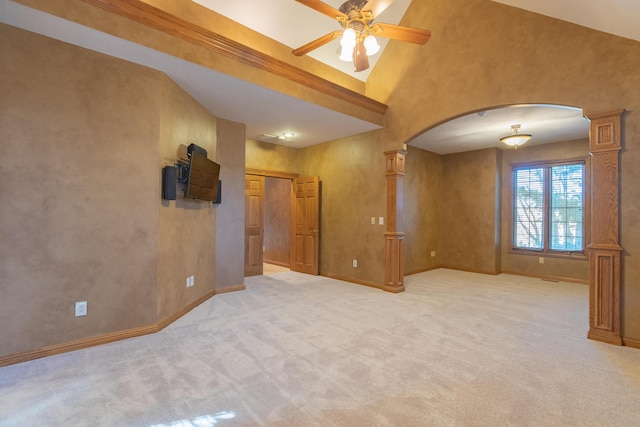 unfurnished room featuring baseboards, light colored carpet, arched walkways, and high vaulted ceiling