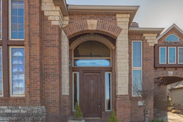 property entrance featuring brick siding