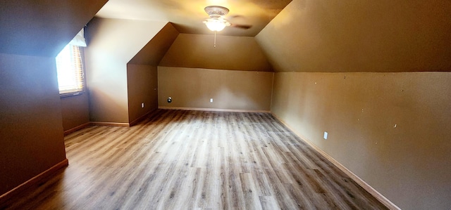 bonus room featuring baseboards, a ceiling fan, lofted ceiling, and wood finished floors