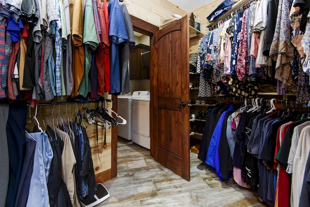 walk in closet featuring washer and dryer and wood finished floors