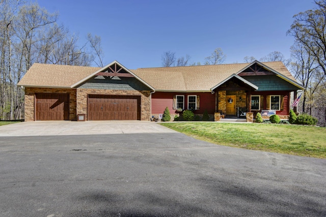 craftsman house featuring concrete driveway, an attached garage, a front yard, and stone siding