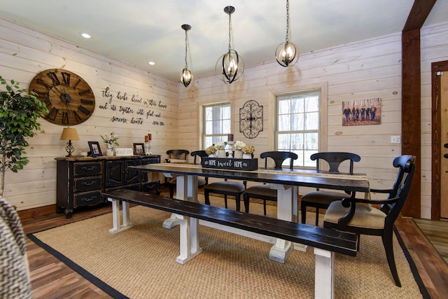 dining room featuring wooden walls, recessed lighting, and wood finished floors