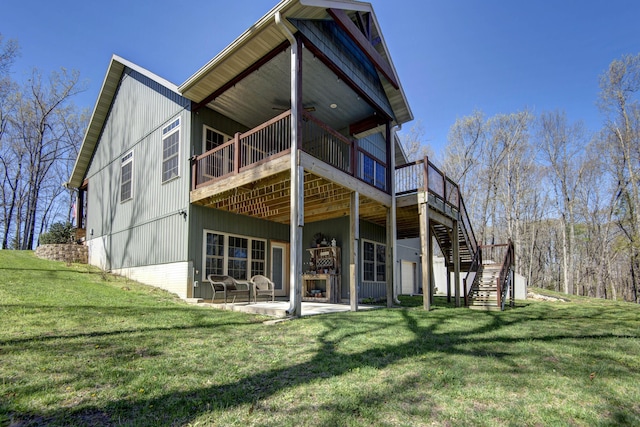 back of property featuring a patio area, a wooden deck, stairs, and a yard