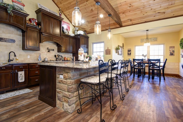 kitchen with dark wood-type flooring, wood ceiling, backsplash, and a sink