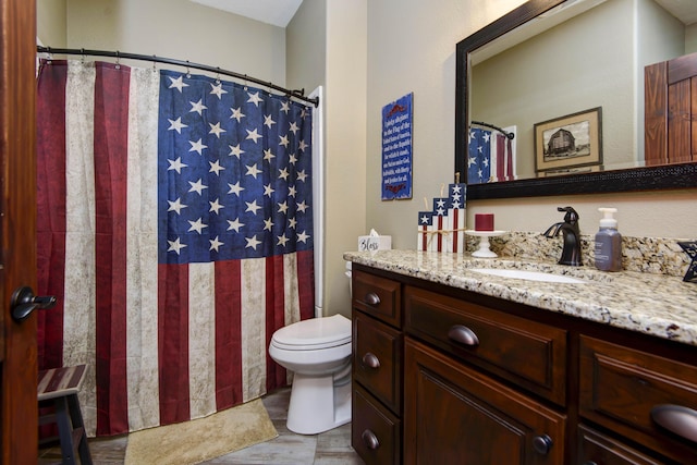 bathroom with a shower with shower curtain, toilet, wood finished floors, and vanity