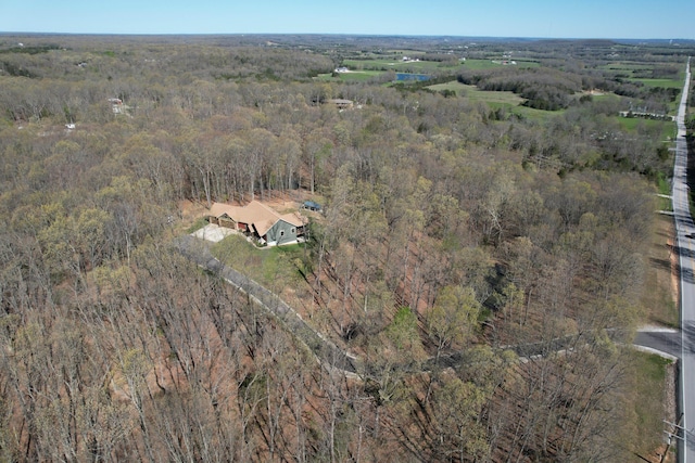 bird's eye view featuring a wooded view