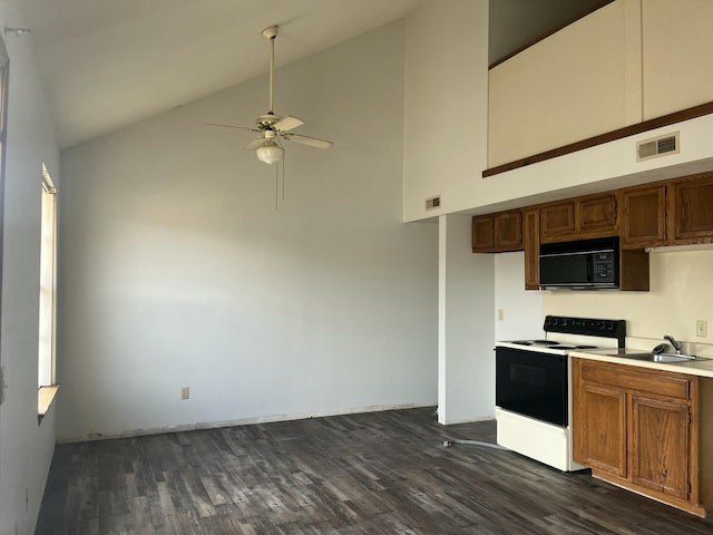 kitchen with visible vents, range with electric cooktop, black microwave, dark wood-style floors, and a sink