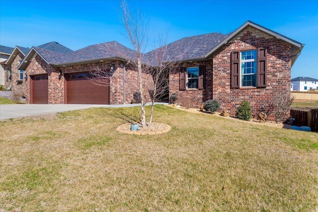 ranch-style home featuring brick siding, a shingled roof, a front lawn, driveway, and an attached garage